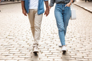 Photo of a couple walking down a brick street. Having trouble in your relationship? Learn how couples therapy in San Francisco, CA can help you start working on your relationship together. 