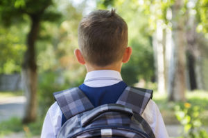 Photo of a young boy standing with his back to the camera carrying a backpack. Is your child struggling with their emotions? Learn how therapy for children in Marin County, CA can help your child develop the skills to manage their emotions.