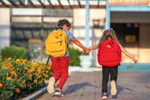 Photo of a young boy and girl holding hands and running with their backpacks. Is your child struggling to control their emotions? Learn how a child therapist can help your child learn the coping skills they need to control their emotions inwith therapy for children in Marin County, CA.