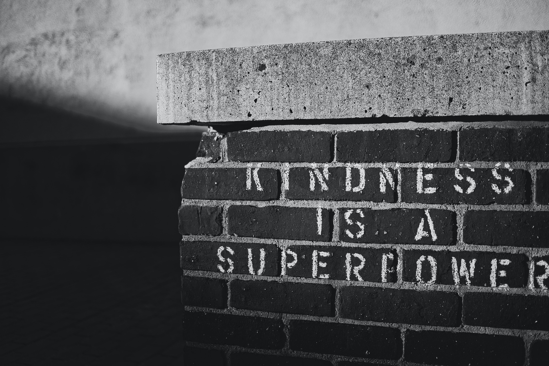 Photo of a brick wall with words that reads kindness is a superpower. Is your teen struggling with their ADHD symptoms? Learn how therapy for teens with ADHD in Marin County, CA can help your teen.