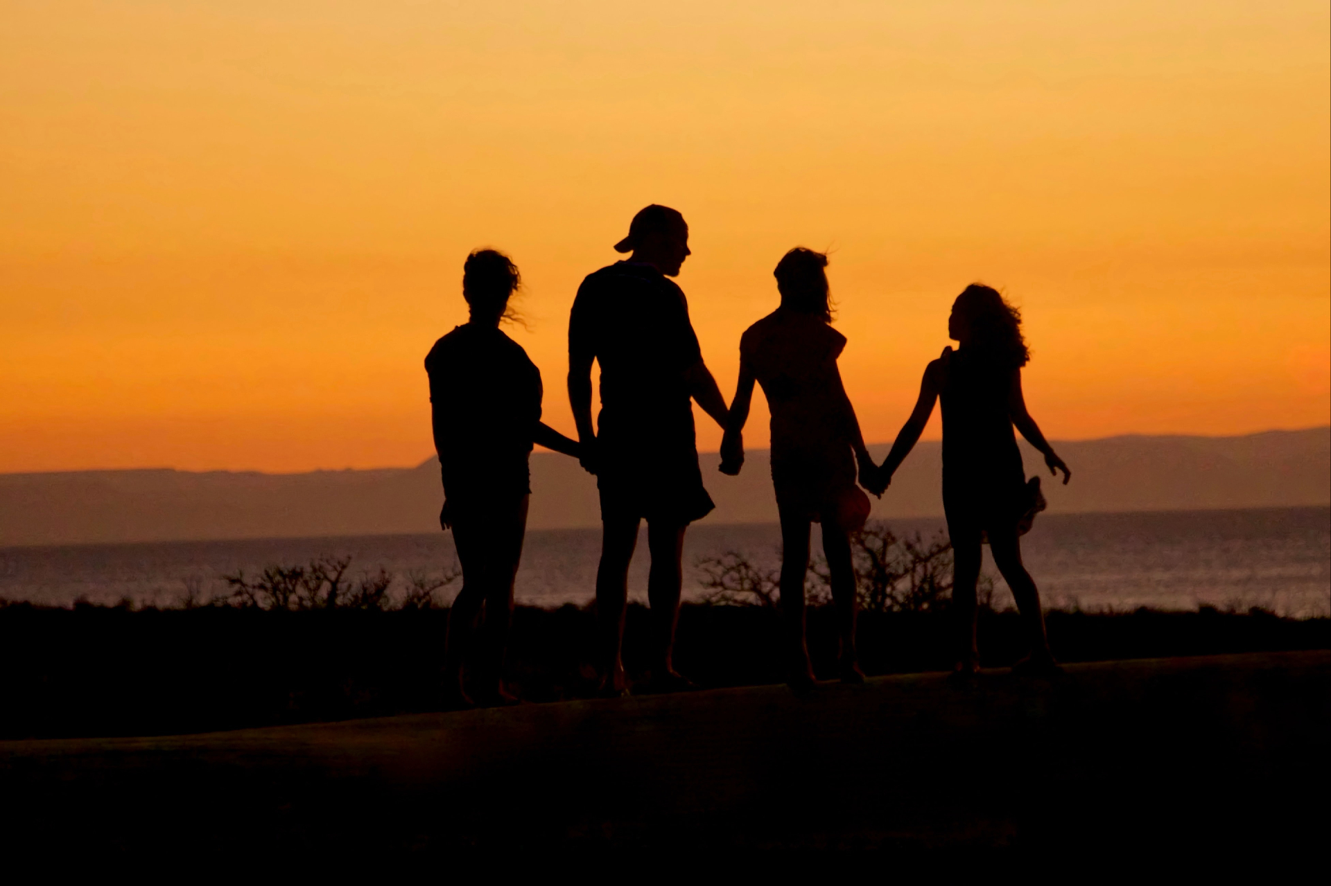Photo of a family standing outside during sunset. Are you struggling to reconnect with your children? Learn how parent coaching in Marin County, CA can help you reconnect.
