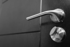 Photo of a door handle and lock. This photo represents the compulsive behaviors some women may show when experiencing anxiety symptoms. Learn the coping skills to control your symtpoms with an anxiety therapist in San Francisco, CA.